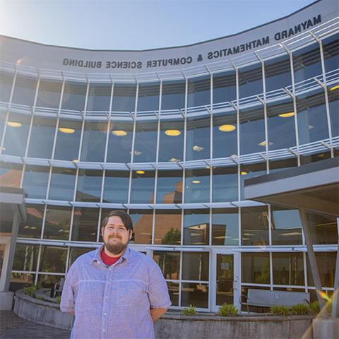 Computer science student in front of Maynard